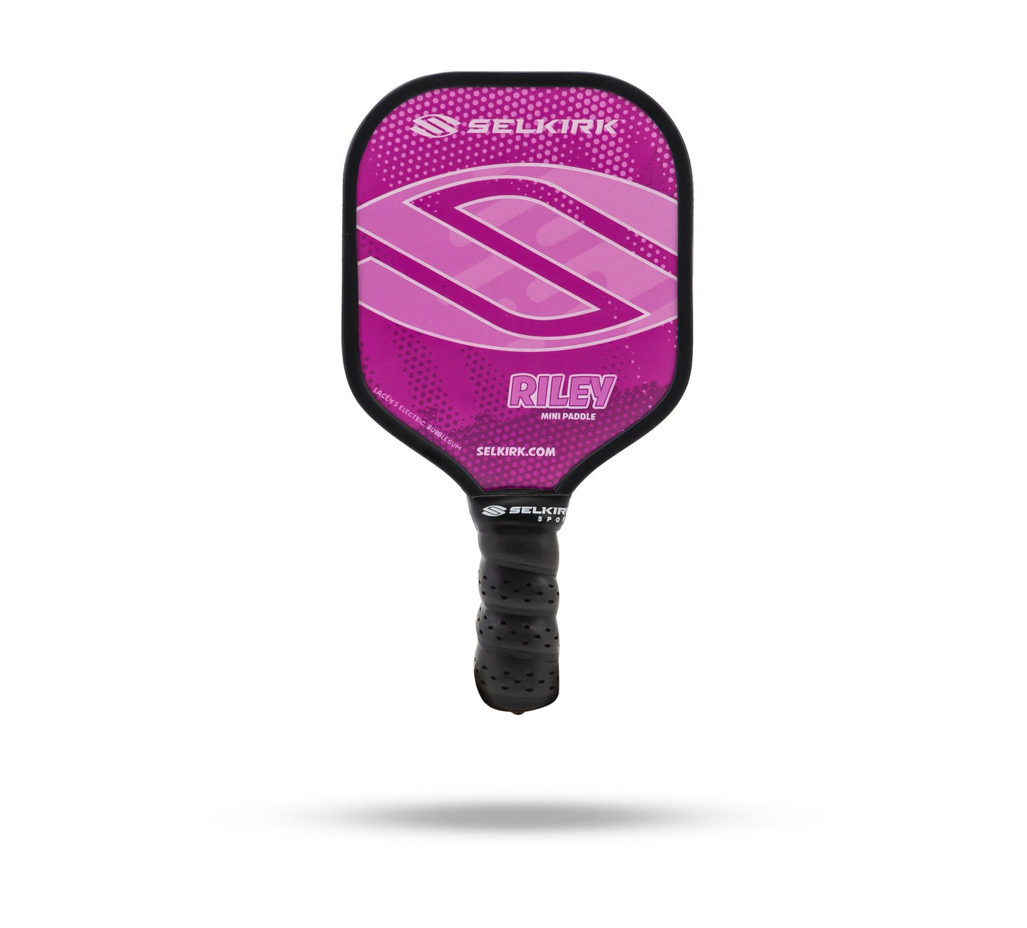 A purple Selkirk Riley Mini Pickleball Paddle with a black grip, featuring the Selkirk logo and brand name, part of the unique Riley Paddle Collection. This novelty gift is adored for its vibrant design inspired by Barnes’ children’s favorite colors.