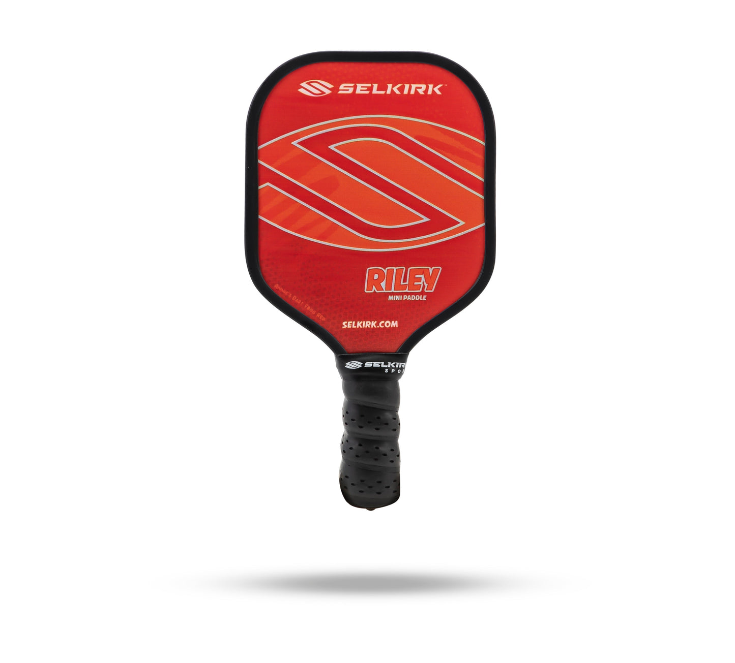 A red Selkirk Riley Mini Pickleball Paddle from the Riley Paddle Collection with a black handle, featuring the Selkirk logo and branding text on its face.