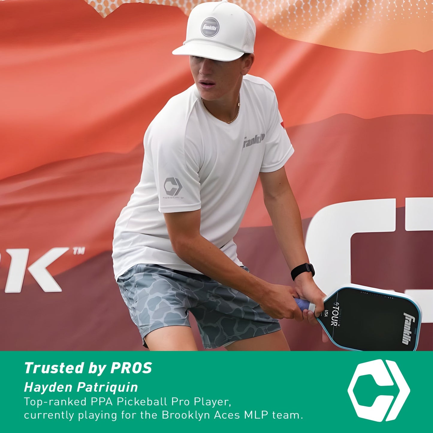 A top-ranked PPA player for the Brooklyn Aces MLP team is in action, wearing a white cap and shirt, wielding a paddle fitted with the Hesacore Gel (Light Blue) Pickleball Grip by Hesacore.