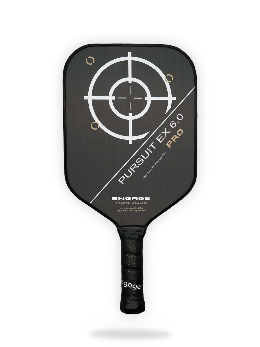 A black Engage Pursuit Pro EX 6.0 Pickleball Paddle with a white target design on the face and "Pursuit EX 6.0 Pro" text diagonally across it. A black grip handle is at the bottom.