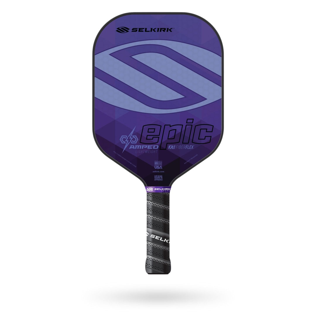 The Selkirk Amped Epic Pickleball Paddle boasts a sleek black and purple face, adorned with the brand logo and name. The handle features a sophisticated black and white grip. As part of Selkirk's line of high-performance paddles, this model comes with a limited lifetime warranty.