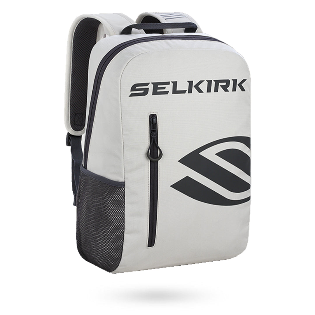 A Pickleballist branded Selkirk Day Backpack (2022) in white and gray with a prominent logo on the front, featuring a side mesh pocket and a zipped main compartment.