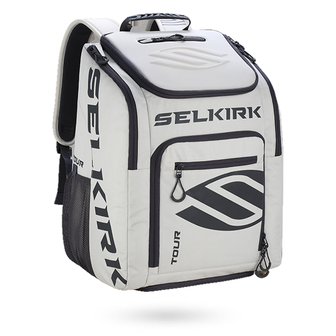 A white and black Selkirk Tour Backpack (2022) Pickleball Bag branded with multiple compartments and a handle on top.