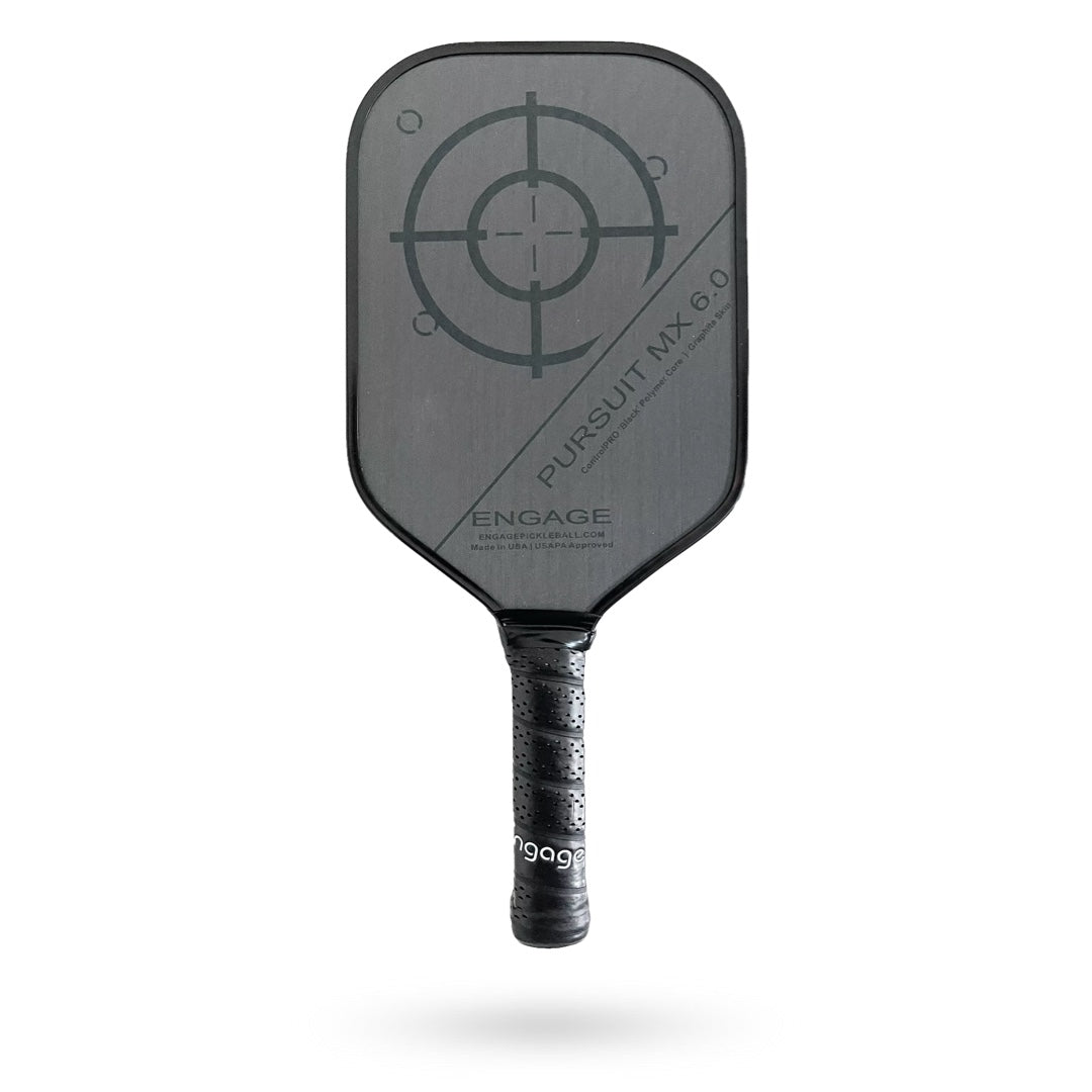 A black and gray Engage Pursuit MX 6.0 pickleball paddle with a target design in the center and text labels, including "engage" and "pursuit mx 6.0," isolated on a white background.