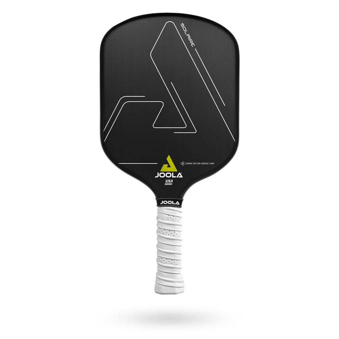A black JOOLA Solaire CFS 14 Pickleball Paddle with white and yellow design accents, featuring a white handle grip and the JOOLA logo near the bottom. The AERO-CURVE technology ensures optimal performance with every swing.