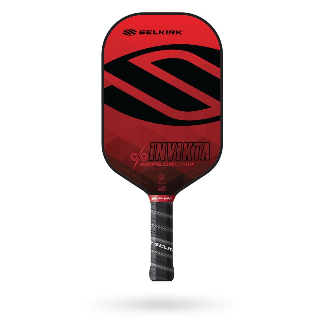 A red and black Selkirk Amped Invikta Pickleball Paddle, branded with "Selkirk," features a sleek design, a black grip handle, Polypropylene X5 Core Technology, and a FiberFlex fiberglass surface.