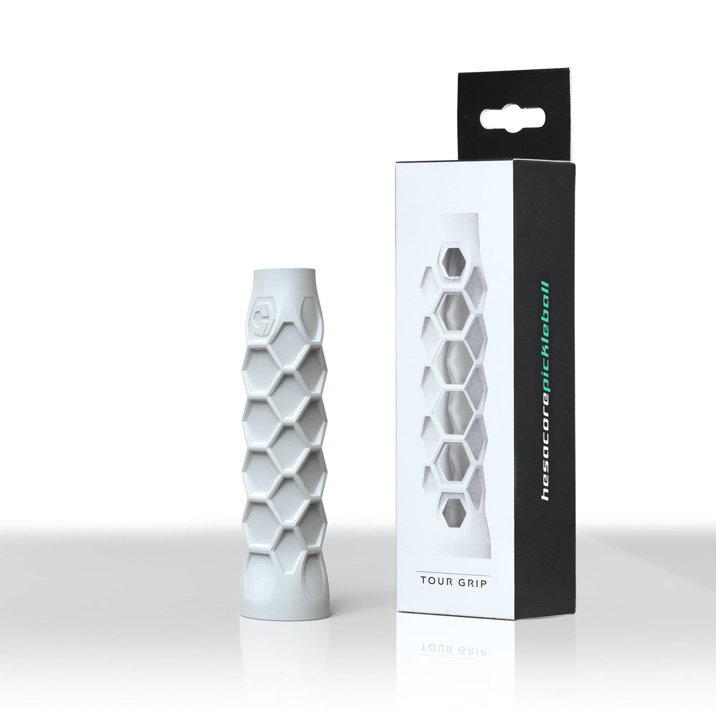 Hexagonal-patterned cylindrical grip beside its packaging box labeled "Hesacore Original (White)" and "hexatronicpickleball.