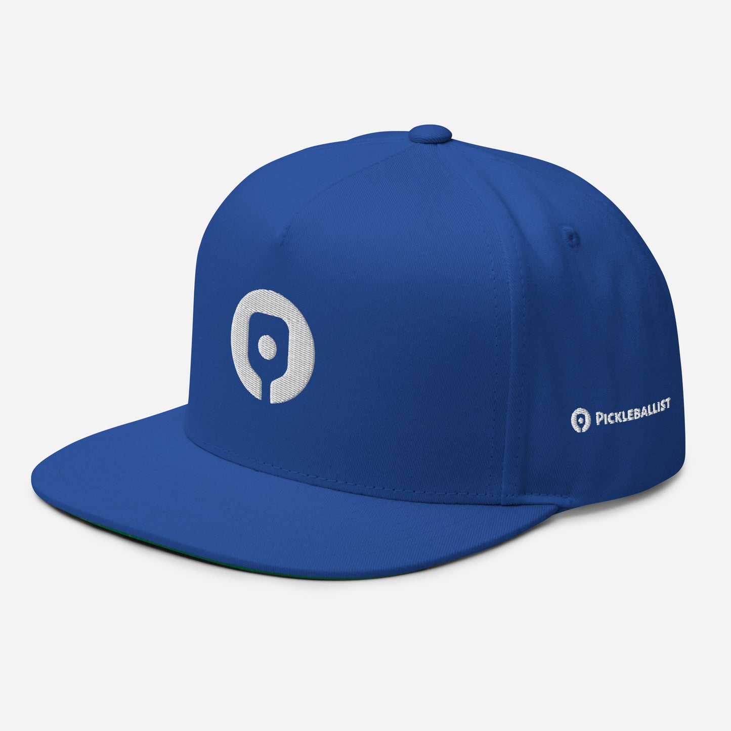 The Pickleballist Signature Logo Flat Brim Pickleball Hat by Pickleballist comes in a striking blue and showcases a white circular logo on the front with "PICKLEBALLIST" emblazoned on the side. Featuring a high-profile fit and snapback closure, it combines style and functionality, making it perfect for any sports enthusiast.
