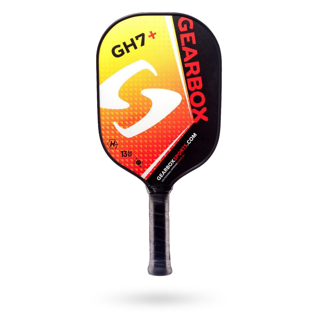 A Gearbox GH7+ Pickleball Paddle with a black handle and a gradient red, yellow, and orange face. The superior construction is evident with the Gearbox logo and website displayed on the paddle.