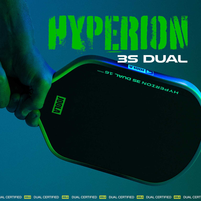 Close-up of a hand holding the JOOLA Hyperion 3S Dual 16mm Pickleball Paddle, featuring sleek green accents and bold JOOLA branding text against a dark background.