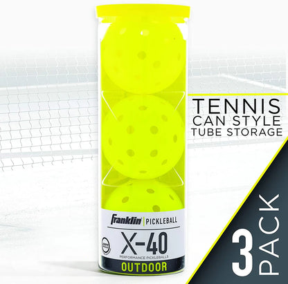 A clear tube contains three Franklin X-40 Outdoor Pickleball Balls in neon yellow. Featuring machine-drilled holes for precision play, they're USAPA approved and labeled "3 Pack" on a net background.