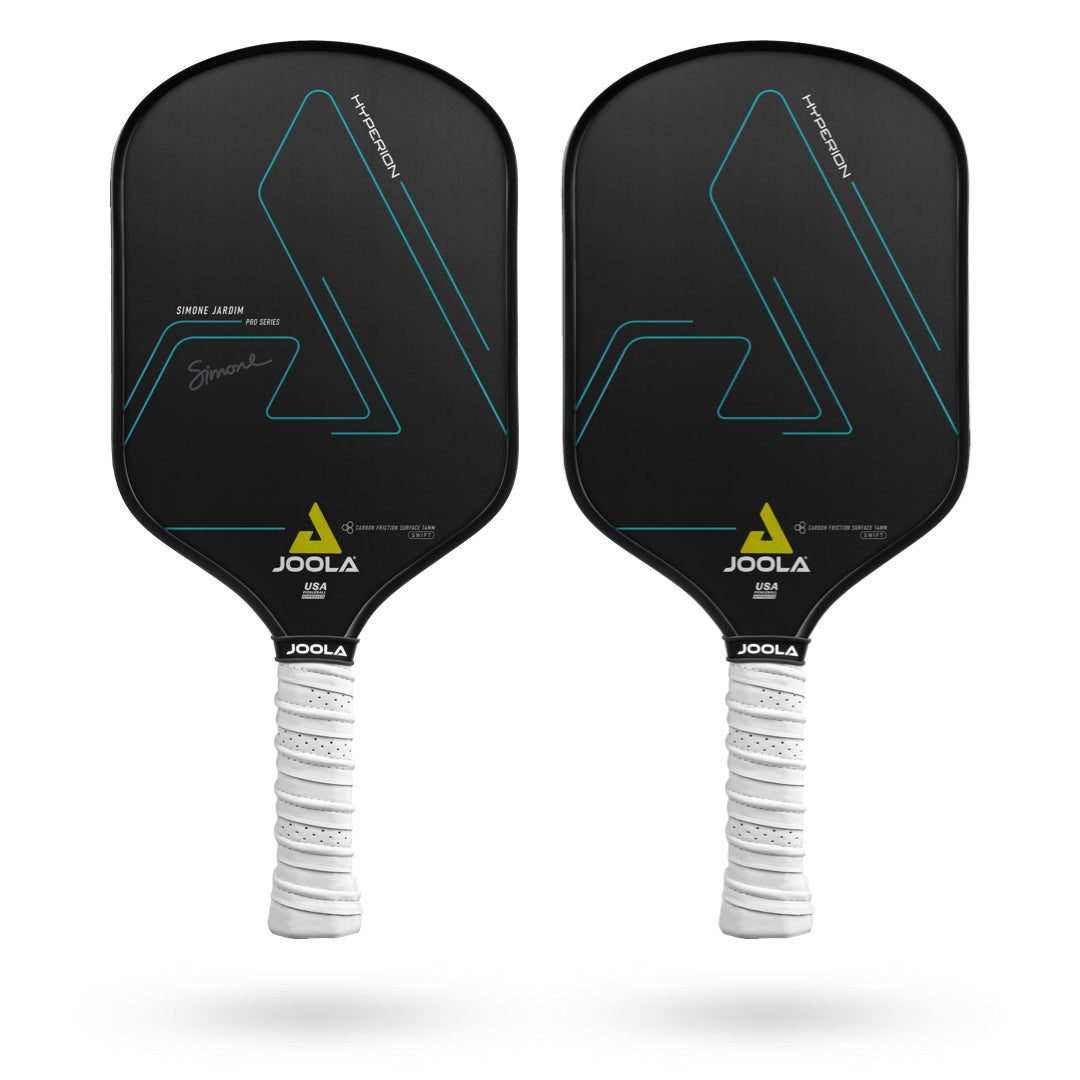 Two JOOLA Simone Jardim Hyperion CFS 14 Swift Pickleball Paddles with black faces and white handles, each featuring a minimalist geometric design and a signature on the left paddle. The paddles boast a CARBON FRICTION SURFACE for enhanced spin and control, paired with a REACTIVE HONEYCOMB POLYMER CORE for ultimate responsiveness.