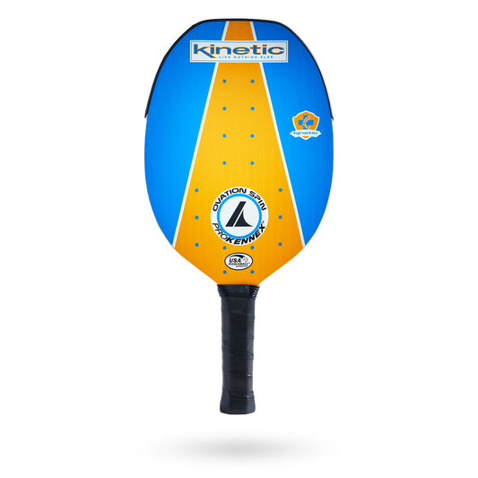 A Pickleballist ProKennex Ovation Spin pickleball paddle, featuring a bright blue face with yellow dots and brand logos, and designed with a Kinetic shock absorbing system.