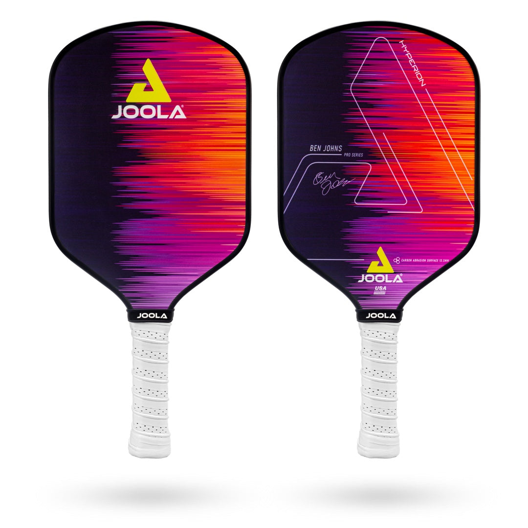 Two JOOLA Ben Johns Hyperion CAS 13.5 Pickleball Paddles with a purple, pink, and orange gradient design, one showing the front and the other showing the back with Ben John's signature. Both feature white grips and an advanced carbon abrasion surface for increased durability.