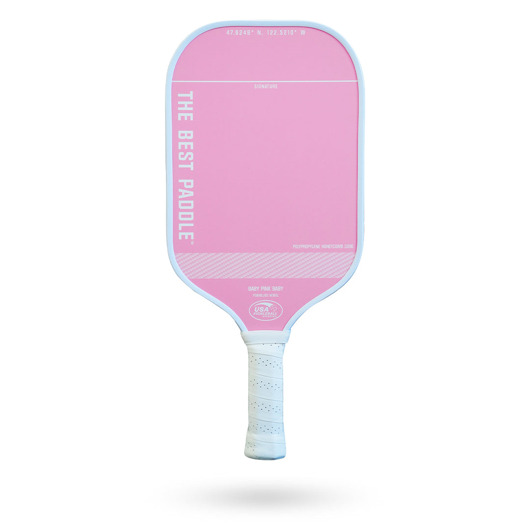 A pink and white The Best Paddle Fiberglass Pickleball Paddle on a white background.