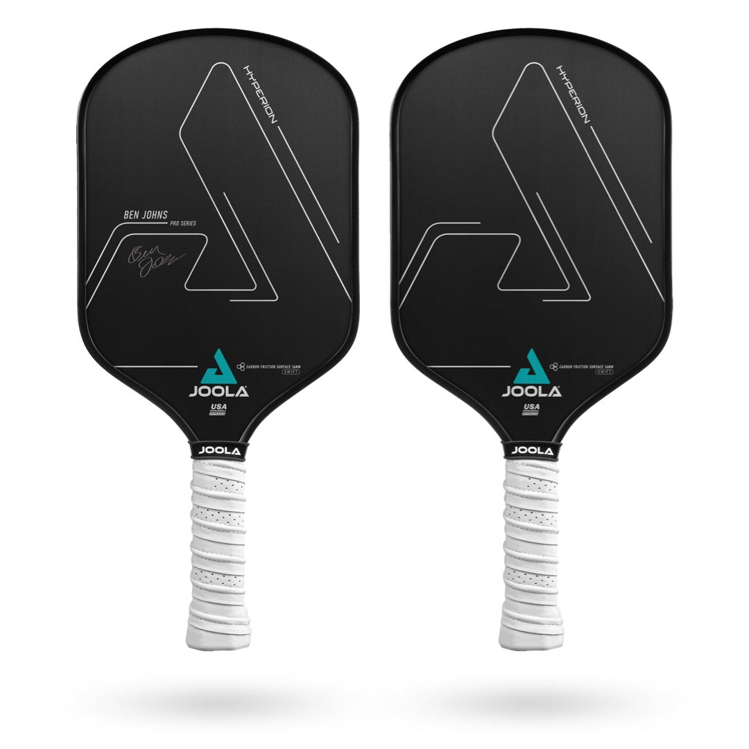 A close up of a JOOLA Ben Johns Hyperion CFS 16 Swift Pickleball paddle with a carbon friction surface.