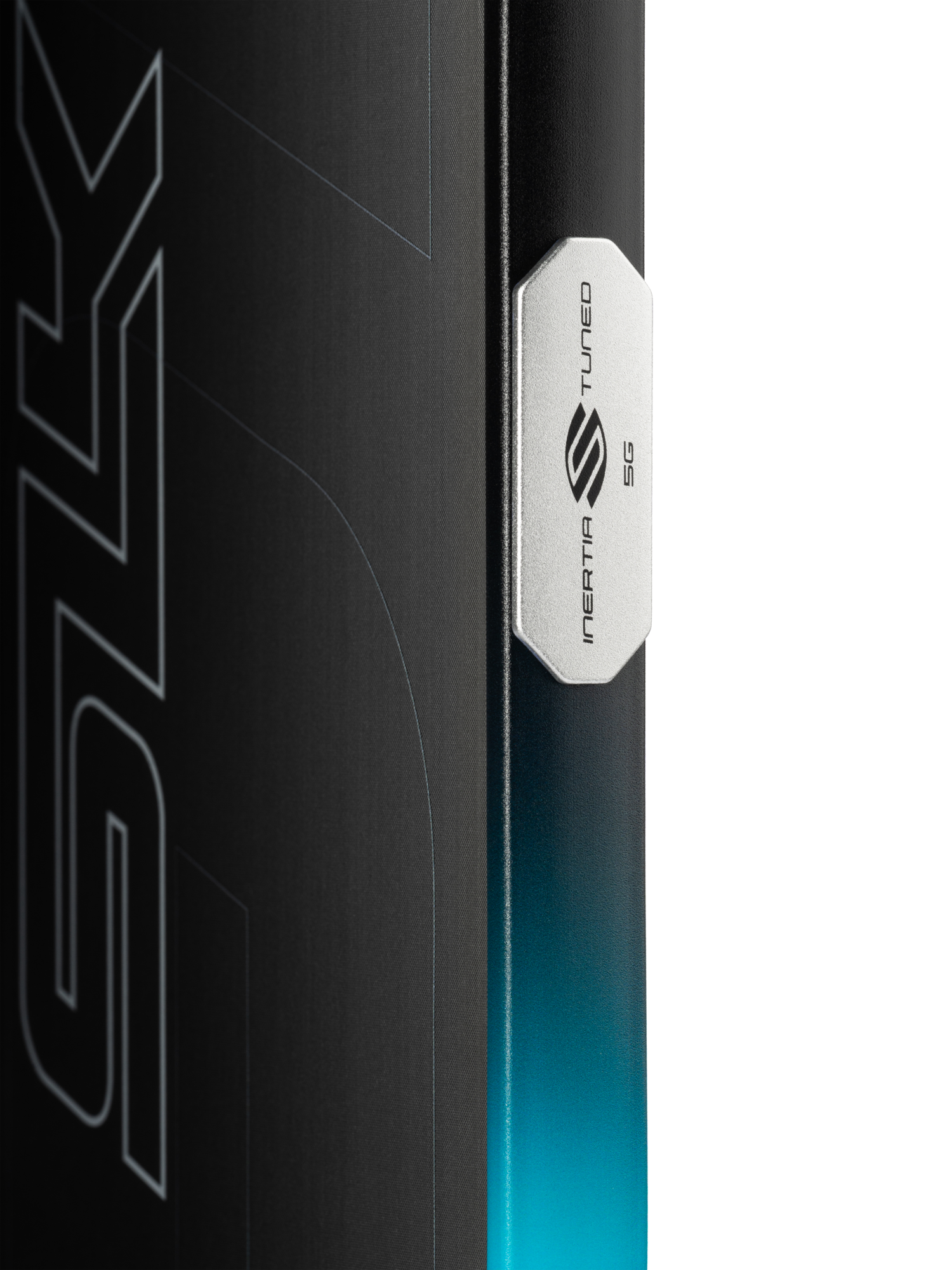 Close-up of the Selkirk SLK GEO Widebody 14mm Pickleball Paddle's edge with a metallic "INERTIA TUNED 5G" badge, highlighting its widebody design against a gradient blue and black background with partial graphic text.