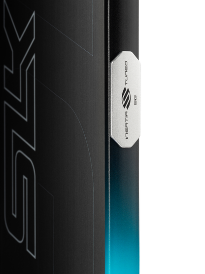 Close-up of the Selkirk SLK GEO Widebody 14mm Pickleball Paddle's edge with a metallic "INERTIA TUNED 5G" badge, highlighting its widebody design against a gradient blue and black background with partial graphic text.