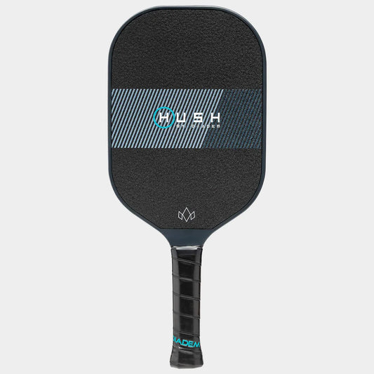 A Diadem Hush Pickleball Paddle, which is black with a textured surface, features the word "Hush" in blue on the face. It has a black grip handle with the brand name "Diadem" visible on the bottom of the handle.