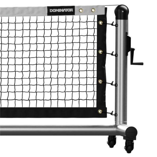 Close-up view of the Dominator Pro Portable Pickleball Net featuring "Dominator" branding, attached to a wheeled metal frame with a side crank mechanism for tension adjustment.