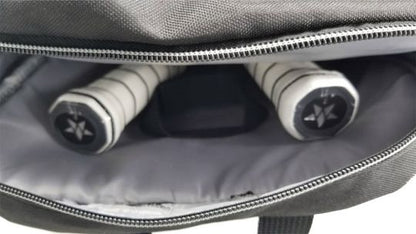 Close-up of an open Pickleballist Master Athletics All-Star Backpack with two rolled-up yoga mats inside, visible through the partially unzipped ventilated compartment.