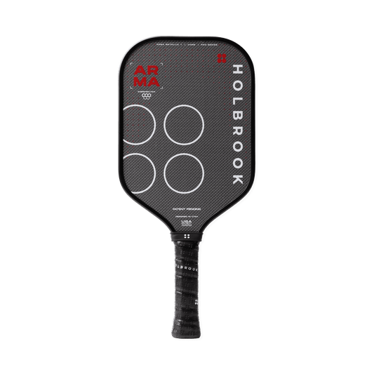 The Holbrook Arma T Metallic 14mm pickleball paddle features a black carbon fiber texture, white circles, and branding on the face and handle, with a Dual-Density™ Core by Holbrook.