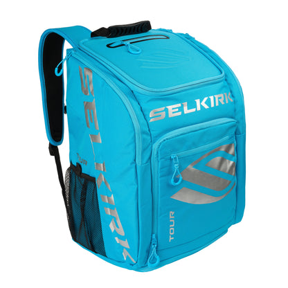 A Selkirk Core Series Tour Backpack Pickleball Bag with multiple compartments, a side mesh pocket, and the brand "SELKIRK" printed in silver text on the front and sides.