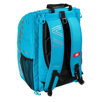 A turquoise blue Selkirk Core Series Tour Backpack Pickleball Bag with black accents, adjustable padded shoulder straps, multiple compartments, mesh side pockets, and Selkirk printed on the side.