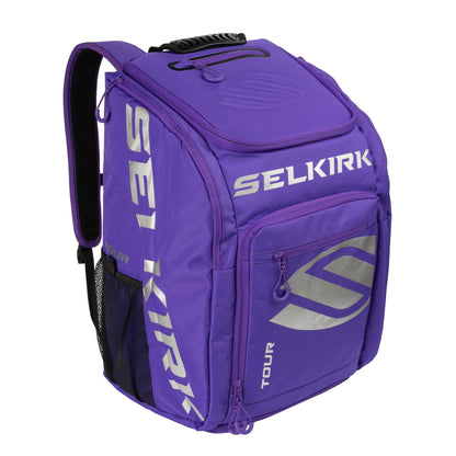 A purple Selkirk Core Series Tour Backpack Pickleball Bag with multiple compartments and zippers, featuring a mesh pocket on the side and a handle on top.