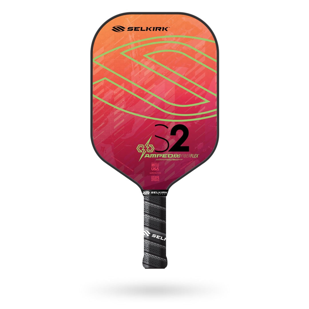 A Selkirk Amped S2 Pickleball Paddle with a pink and orange design.