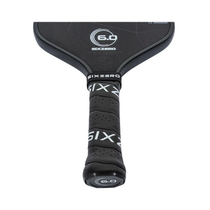 Close-up of a black Six Zero Double Black Diamond Control (14mm) Pickleball Paddle handle wrapped in black grip tape with "SIXZERO" and "6.0" logos visible.