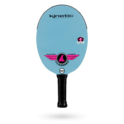 A blue pickleball paddle with a black handle and the brand logo "ProKennex" on top, featuring "ProKennex Kinetic Ovation Flight Pickleball Paddle" and a pink wing design in the middle. This USAPA Sanctioned Tournament-ready paddle boasts a Carbon with diamond frost face for enhanced performance.