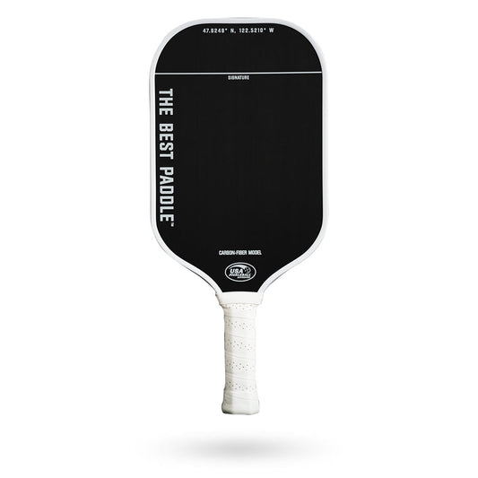 A paddle with a white handle: The Best Paddle Carbon Fiber Pickleball Paddle with a white handle.