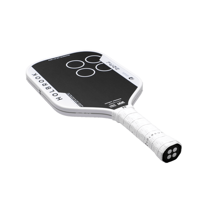 The Holbrook Fuze Elongated 16mm Pickleball Paddle is black and white with a rectangular shape, white grip, circular designs on the face, and a Carbon-Aramid-Carbon surface. The paddle is labeled "HOLBROOK.