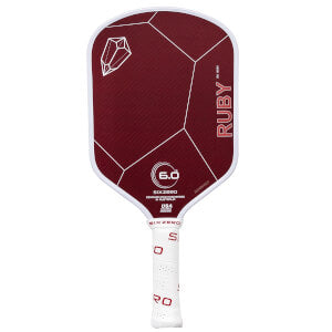 Close-up of a maroon-colored pickleball paddle with a geometric design, labeled "Six Zero Ruby Kevlar (14mm) Pickleball Paddle" and featuring a white handle.