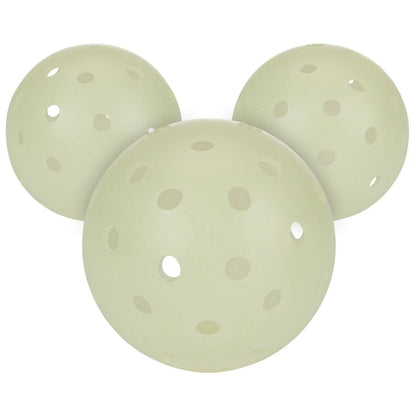 Three perforated, pale green spherical objects resembling a Mickey Mouse head silhouette are actually Franklin X-40 Glow-In-The-Dark Pickleball Balls by Franklin, designed for premium performance during night matches.