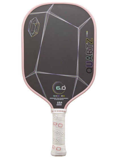 A black and pink "Six Zero Quartz (15mm)" pickleball paddle with a geometric design, featuring a white handle wrapped in grip tape.