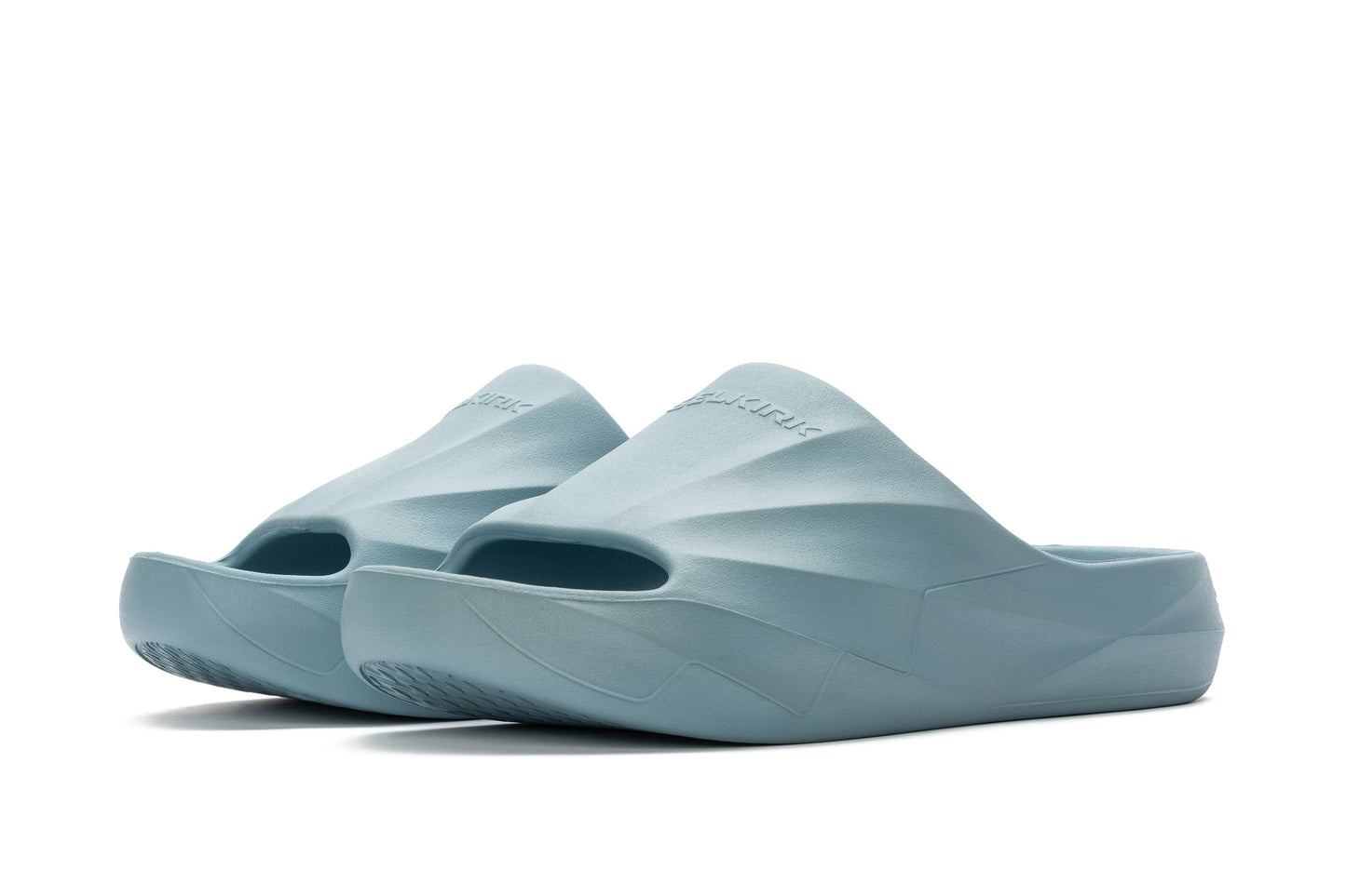 The Selkirk Podium Slide Sandal Pickleball Shoes are light blue slip-on sandals featuring a sleek design and open-toe style, displayed against a white background.