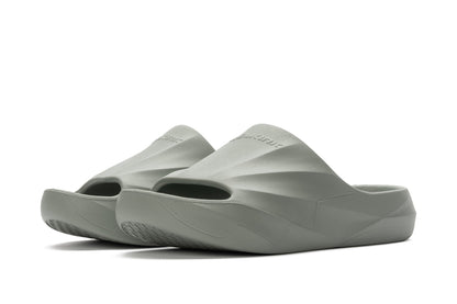 A pair of Selkirk Podium Slide Sandal Pickleball Shoes, featuring a gray textured design with open toes and thick soles, displayed on a white background.