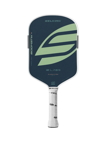 The Selkirk LABS Project Boomstik Elongated 16mm Pickleball Paddle with Infinigrit features a dark blue face, large green "S" logo, and white branded grip handle—engineered by Selkirk for advanced spin and control.