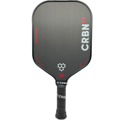 A black pickleball paddle labeled "CRBN 2X Power Series - 14mm Square Pickleball Paddle" with "CRBN" written on the side and a "USA Pickleball Approved" logo near the handle.