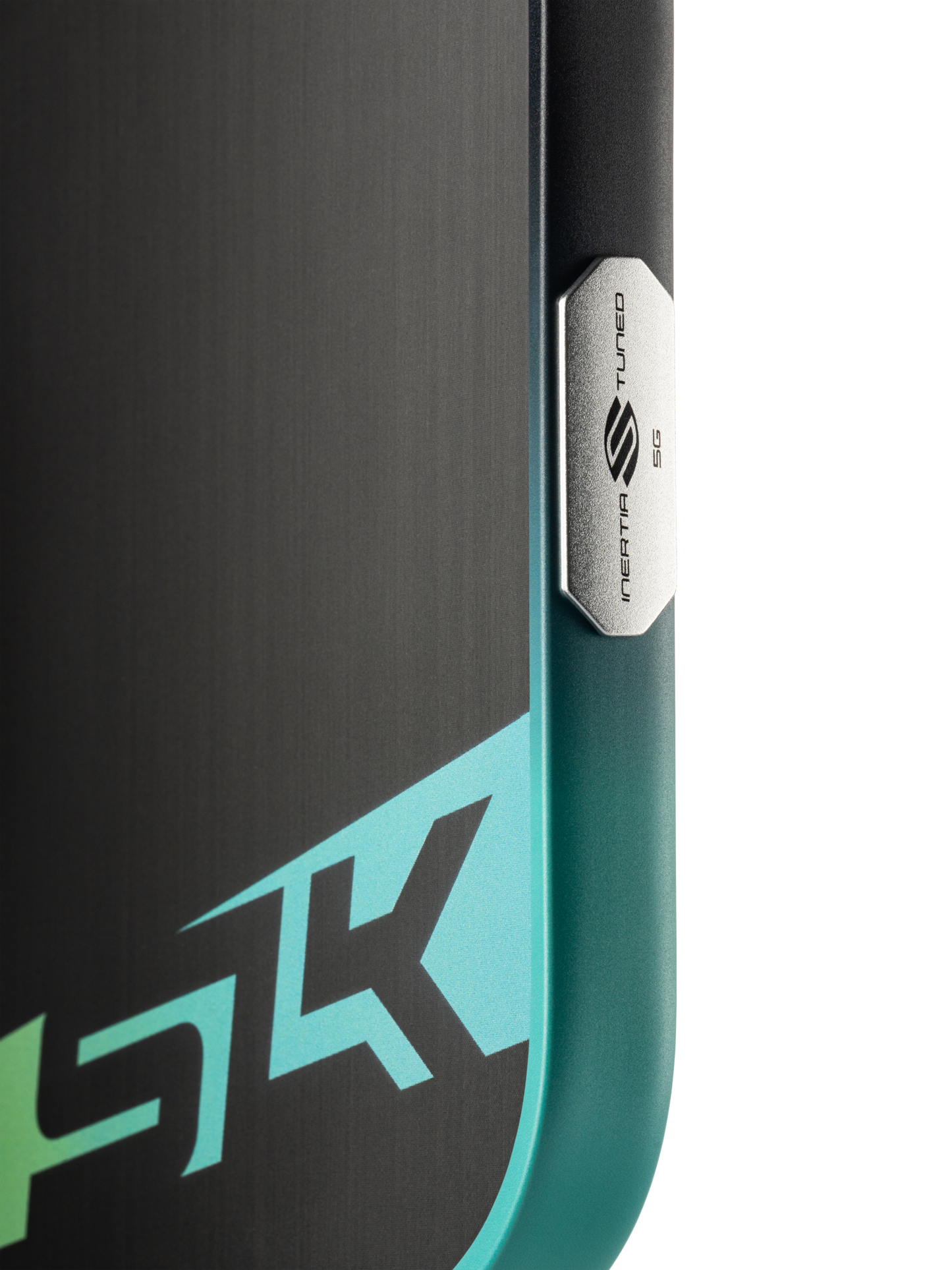 Close-up of a device with a metallic "NEAR TUNED 5G" button and partial "5K" graphic in teal and white, echoing the sleek look of the Selkirk SLK Dauntless Elongated 16mm Pickleball Paddle by Selkirk.