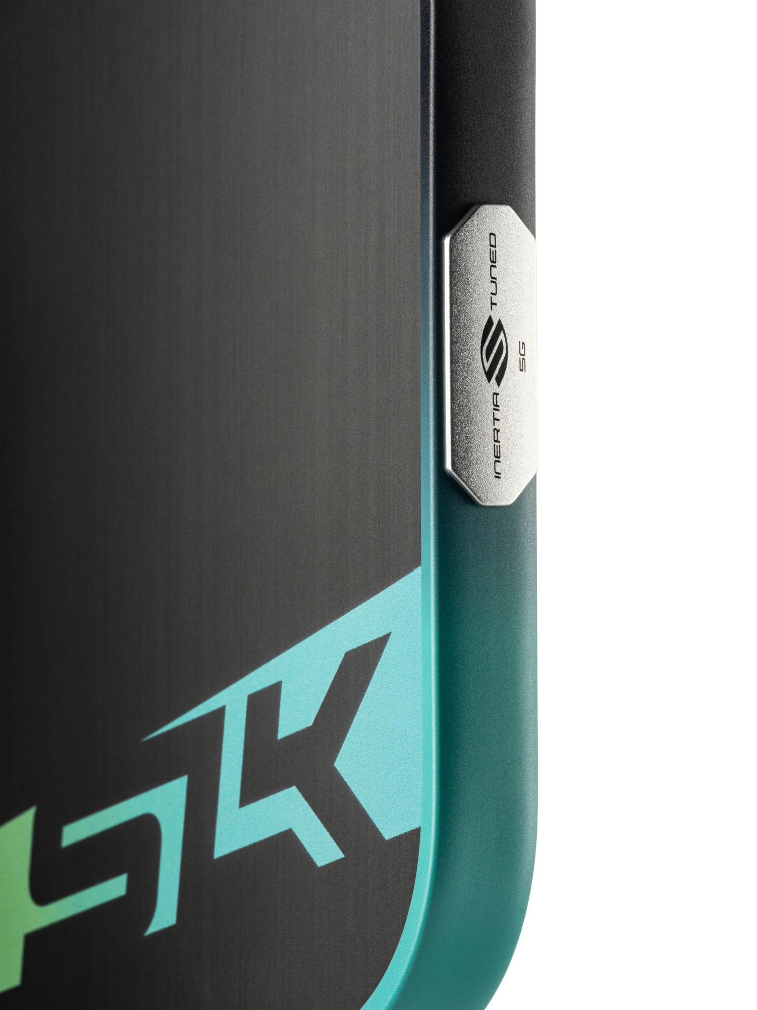 Close-up of a device with a metallic "NEAR TUNED 5G" button and partial "5K" graphic in teal and white, echoing the sleek look of the Selkirk SLK Dauntless Elongated 16mm Pickleball Paddle by Selkirk.