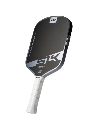 A Selkirk SLK Dauntless Elongated 16mm Pickleball Paddle in black and gray with a white grip and "SLK" branding on the face, shown against a white background.
