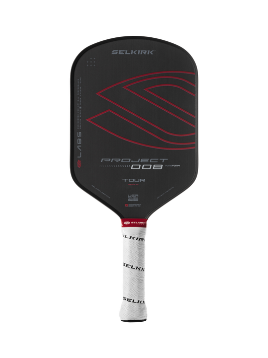 The Selkirk Labs Project 008 Tour Elongated 16mm Pickleball Paddle features a black design with red accents and a white handle grip inscribed with black text.