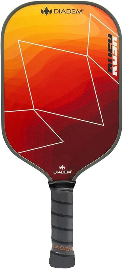 The Diadem Rush Pickleball Paddle features a black handle and a vibrant geometric design in red, orange, and yellow on the face, with the brand "Diadem" marked prominently on it.