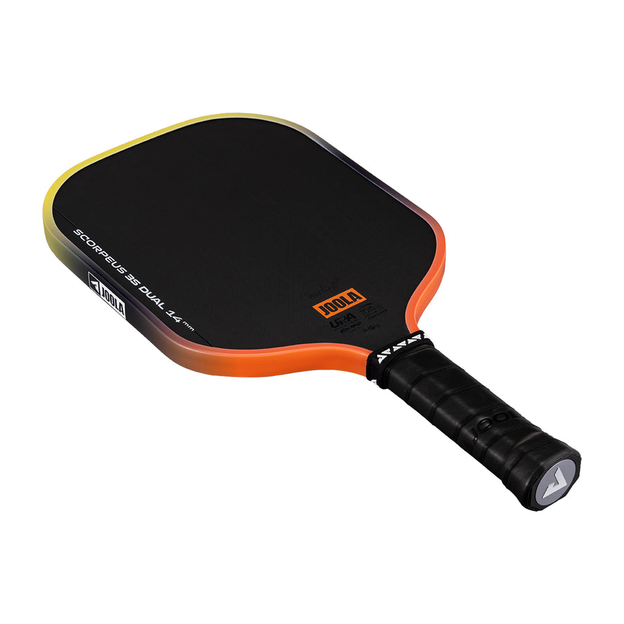 The Pickleballist JOOLA Scorpeus 3S Dual 14mm Pickleball Paddle in black with orange and yellow trim features a wrapped grip and a Carbon Friction Surface for improved spin and control.