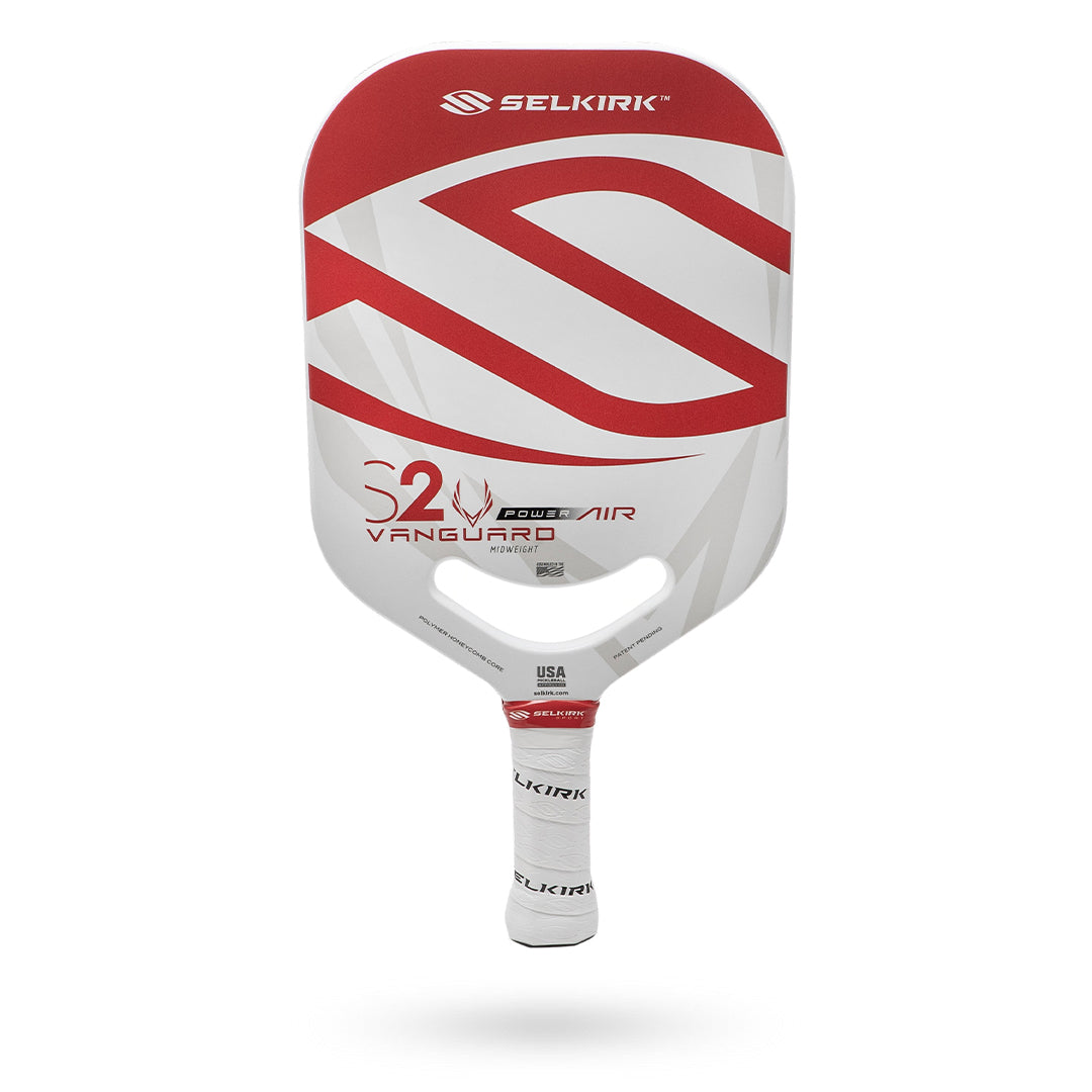 A Pickleballist Selkirk Power Air S2 pickleball paddle with a white and red design on the front and a grip handle, featuring a Limited Lifetime Warranty, isolated on a white background.