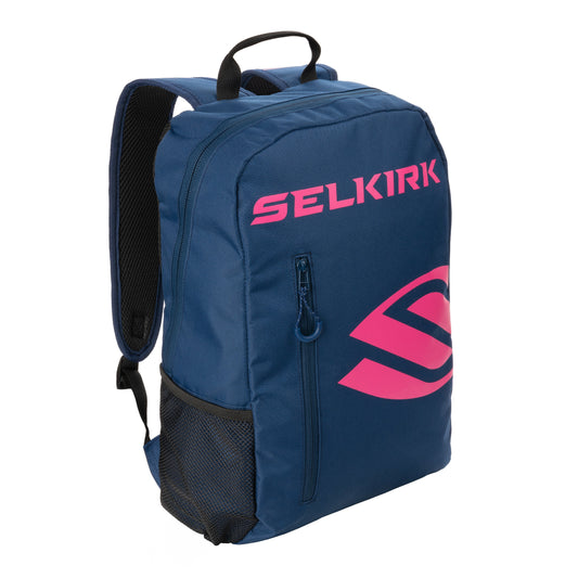 A blue Selkirk Core Series Day Backpack Pickleball Bag with "SELKIRK" and an abstract design in pink. It has adjustable straps, a side mesh pocket, and a top handle.