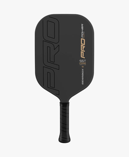 A black Gearbox Pro Power Fusion Pickleball Paddle with the word "PRO" in large letters, featuring a textured handle and the Gearbox logo. The paddle, part of the Gearbox Pro Series, has "PRO POWER" and "SST Core Solid Span Technology" printed on it.